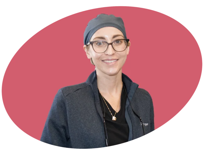 Image of a dentist wearing a cap smiling for a picture